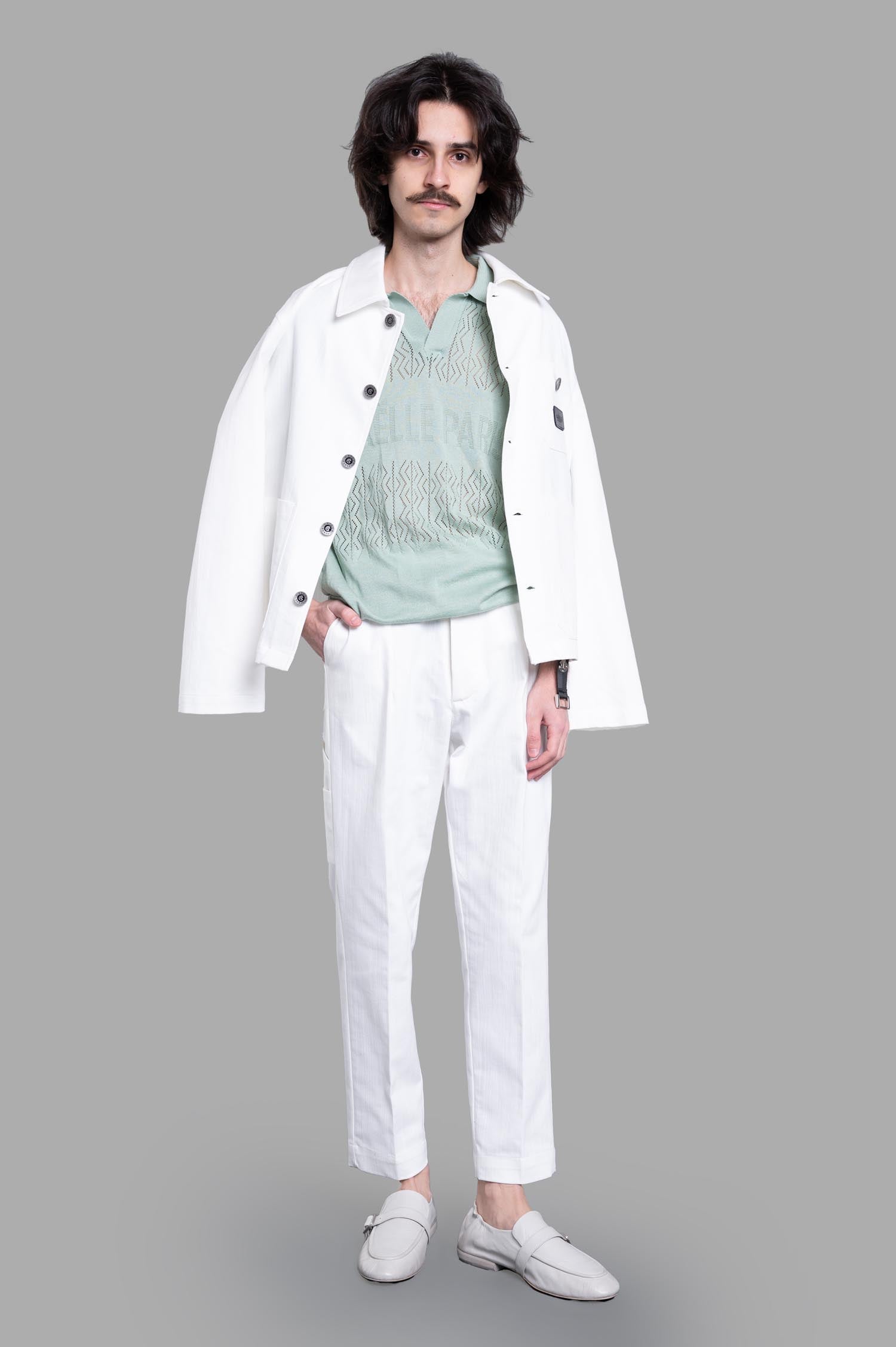Gaëlle Paris mint knit polo shirt with classic collar and logo, worn under white jacket, displayed on-model.