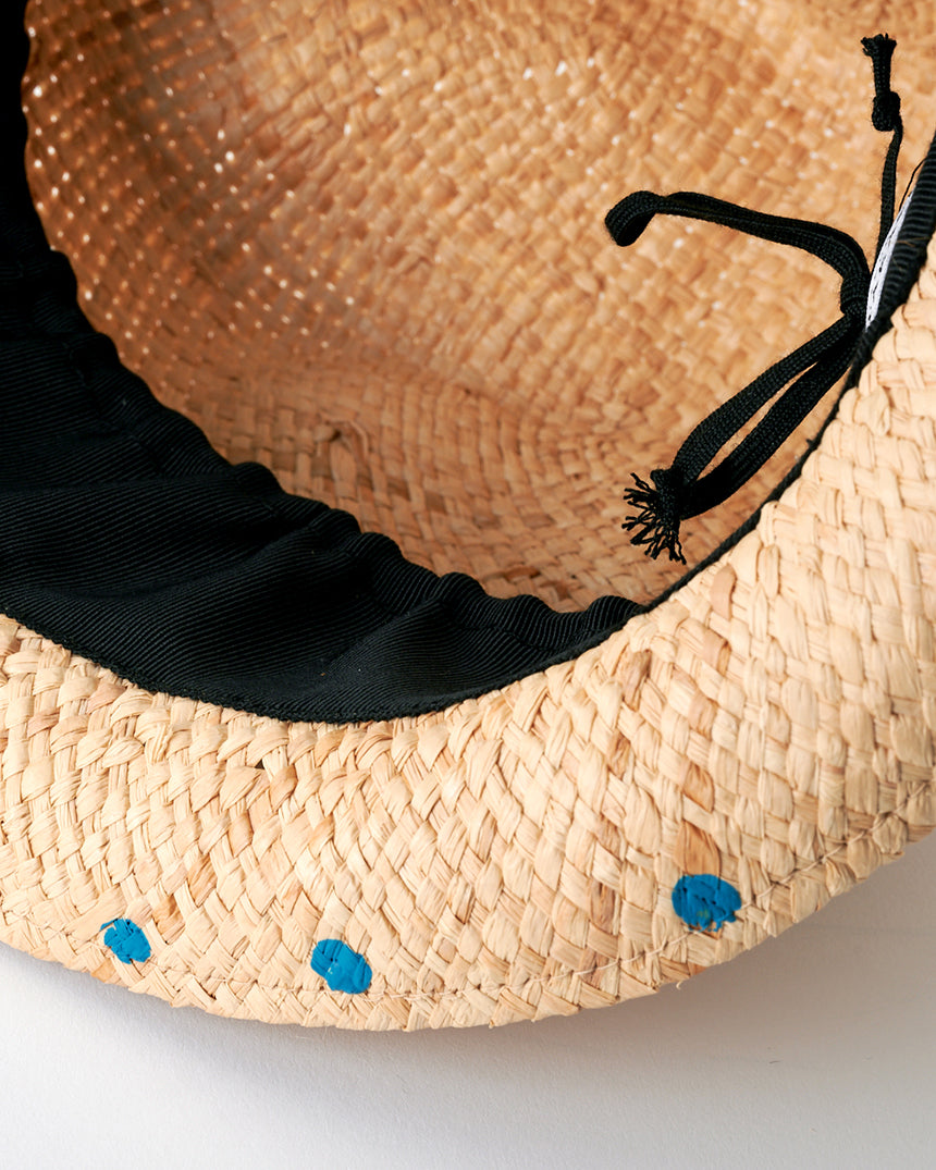 Kijima Takayuki Straw Buffalo Hat interior close-up showcasing beige raffia and decorative blue dots for added flair.