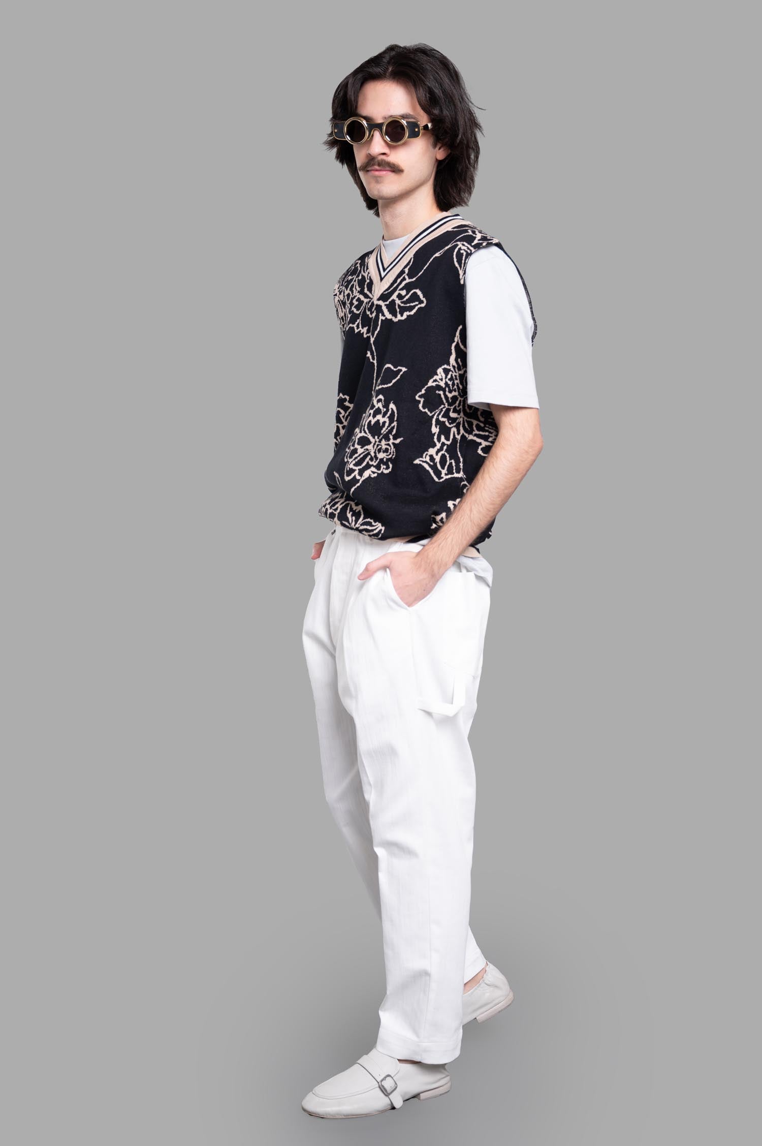 Gaëlle Paris straight-leg pants in white, front view on model, featuring side pockets and front crease.