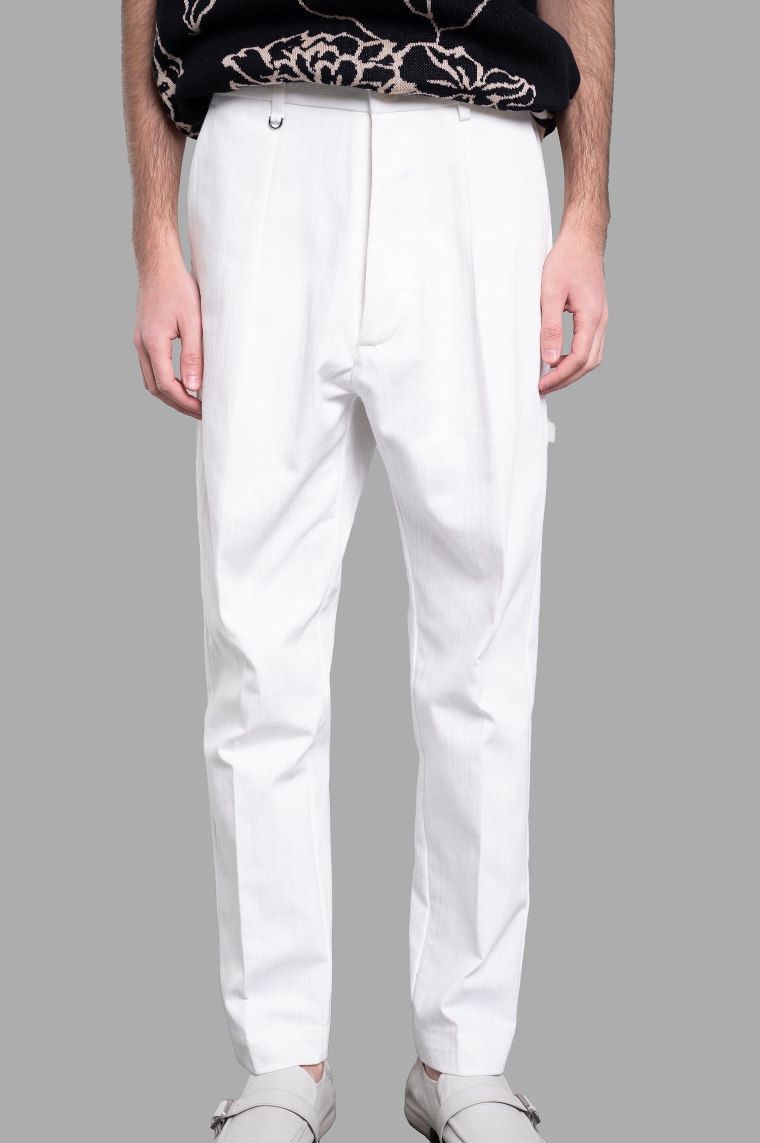 Gaëlle Paris Straight-leg Pants in white, featuring side pockets and a sophisticated front crease, styled on a model.