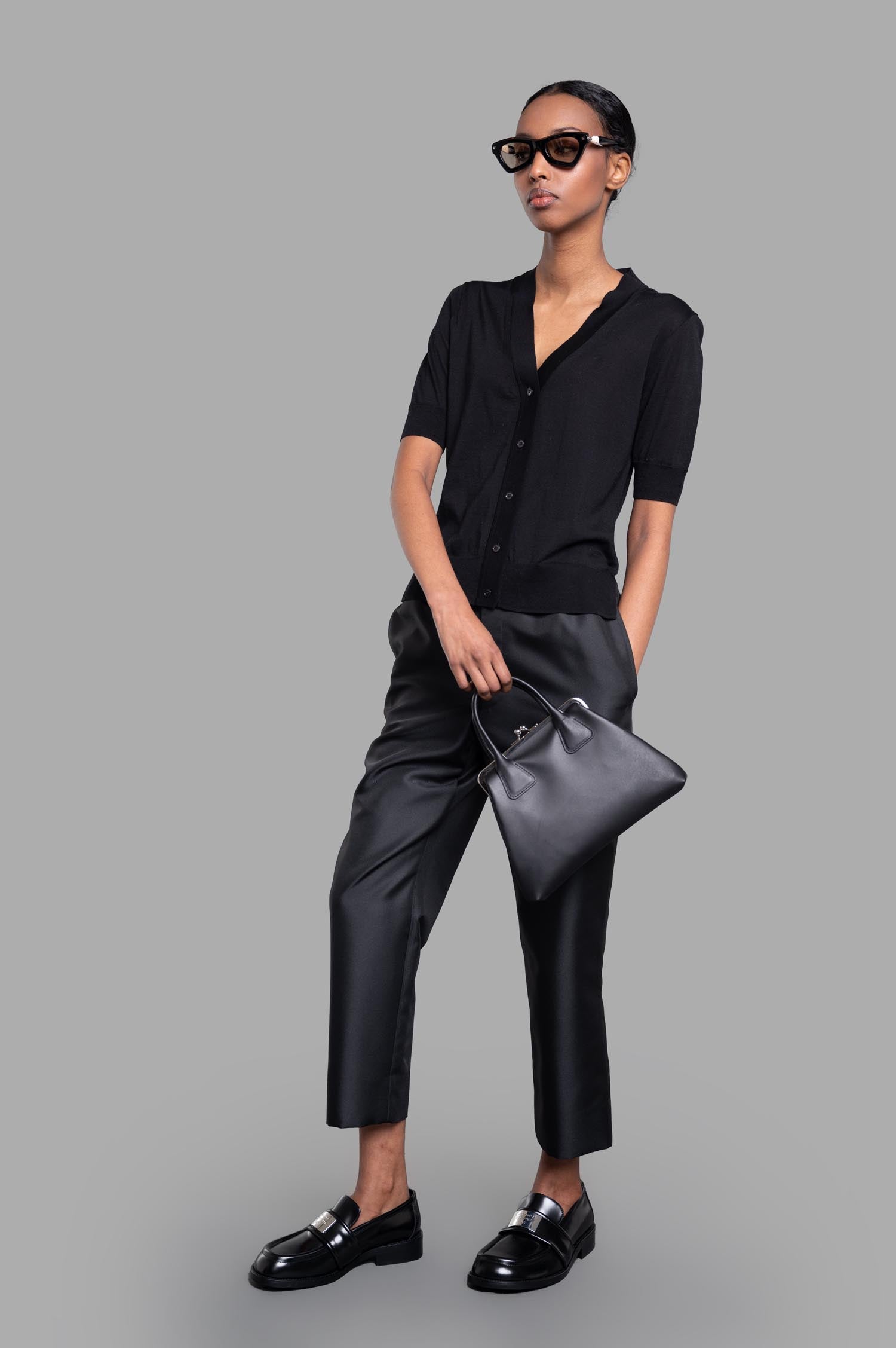 Comme des Garçons Cropped Trousers in black, on-model, showcasing front view with elastic waistband and side pockets.