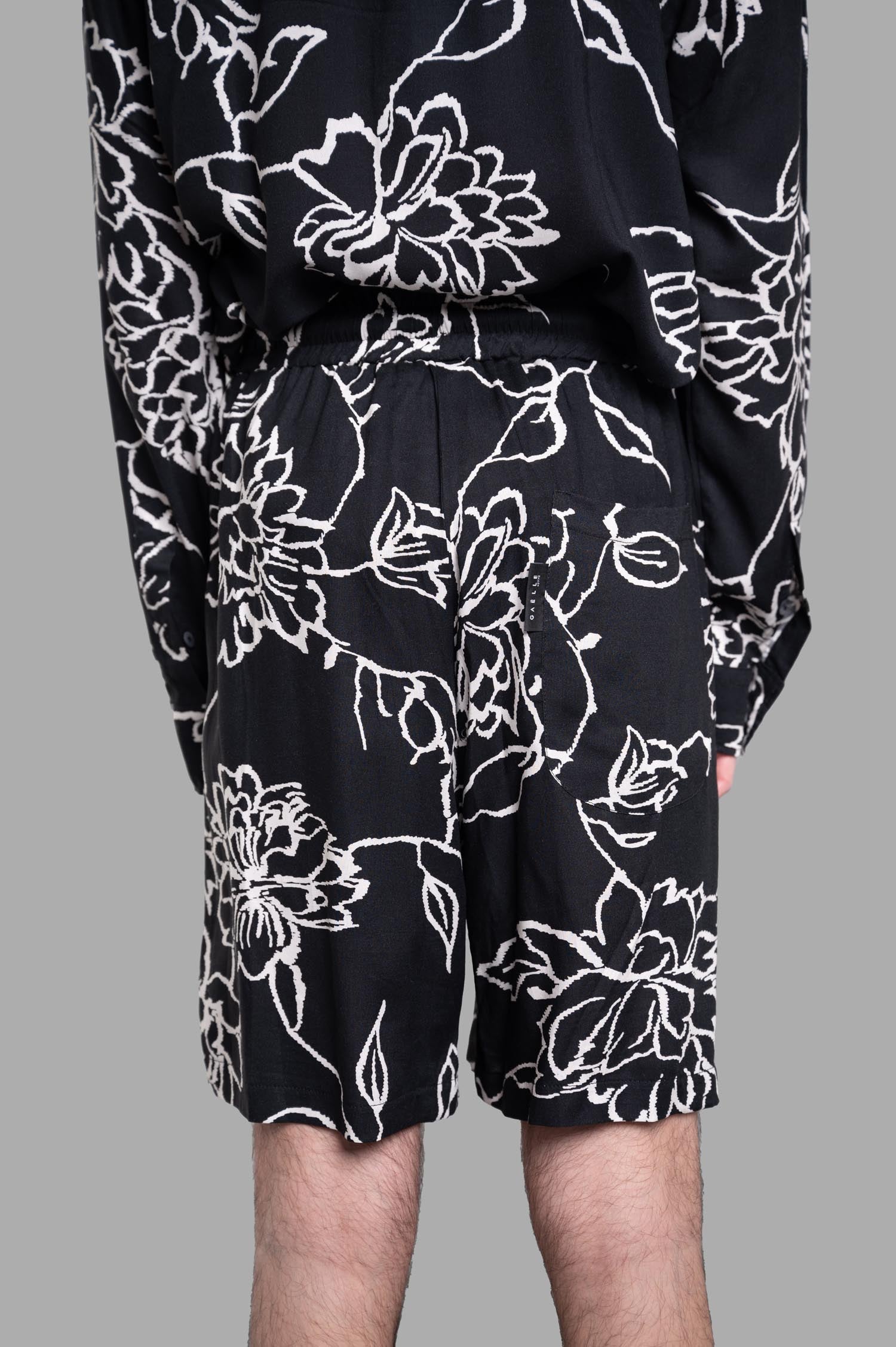 Gaëlle Paris Floral Shorts, stylish Bermuda shorts with floral design, elastic waistband, and side pockets, shown from back.