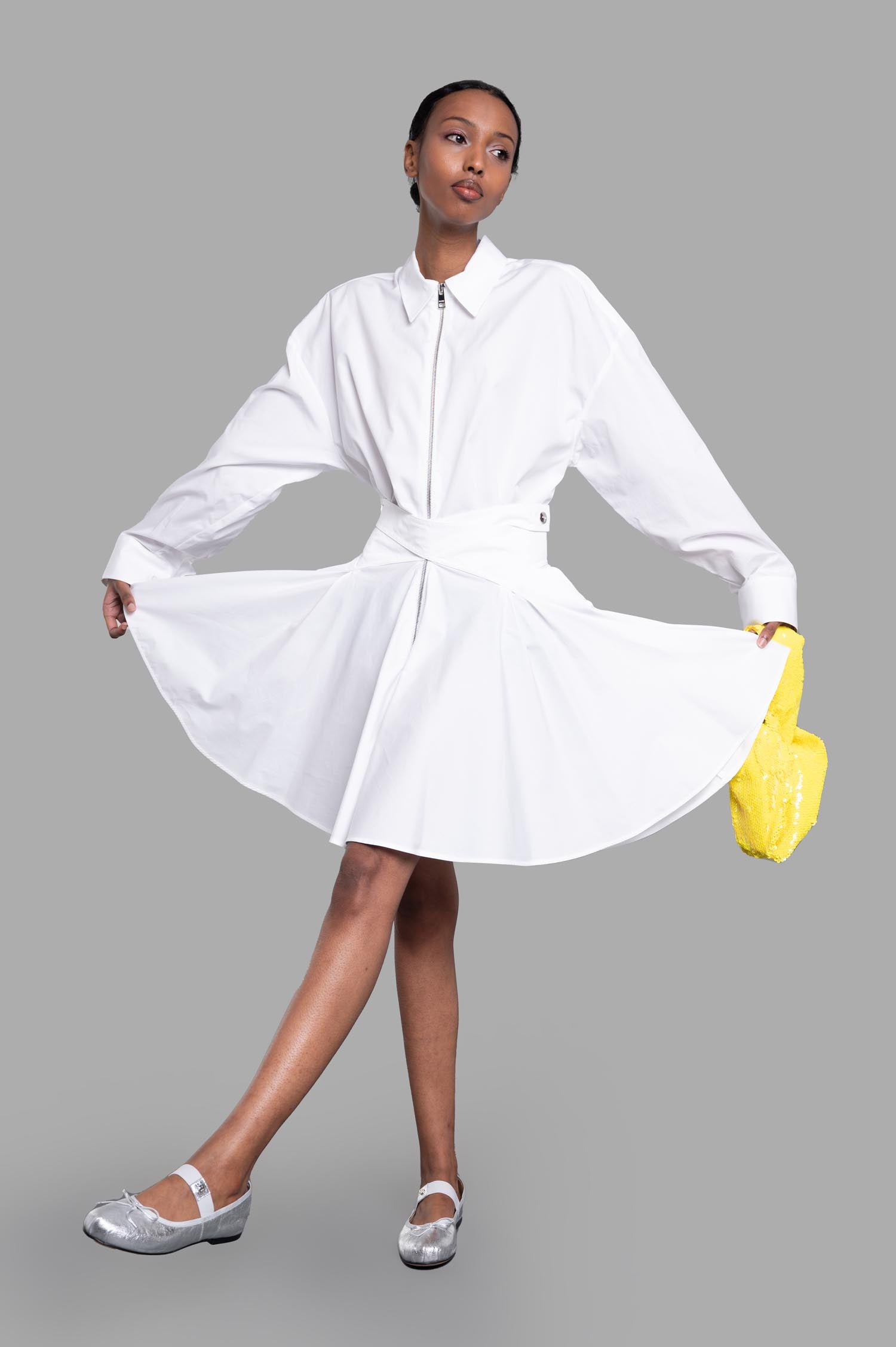 MSGM white Tennis Dress, front view on-model, showcasing A-line silhouette, classic collar, and zipper, with pleated skirt.