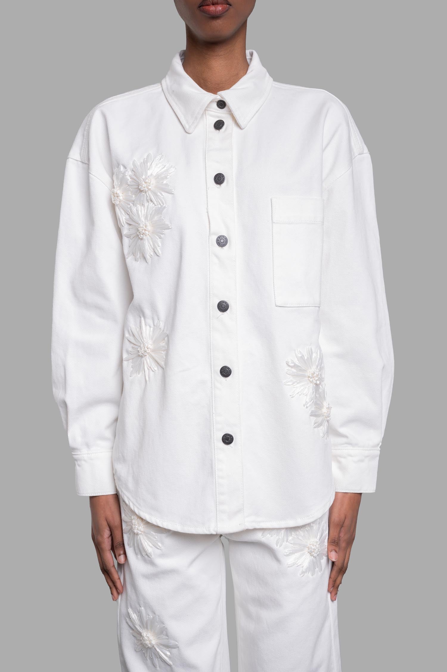 MSGM Denim Shirt with Raffia Flowers in white, featuring embroidered flowers and button details in a stylish front view.