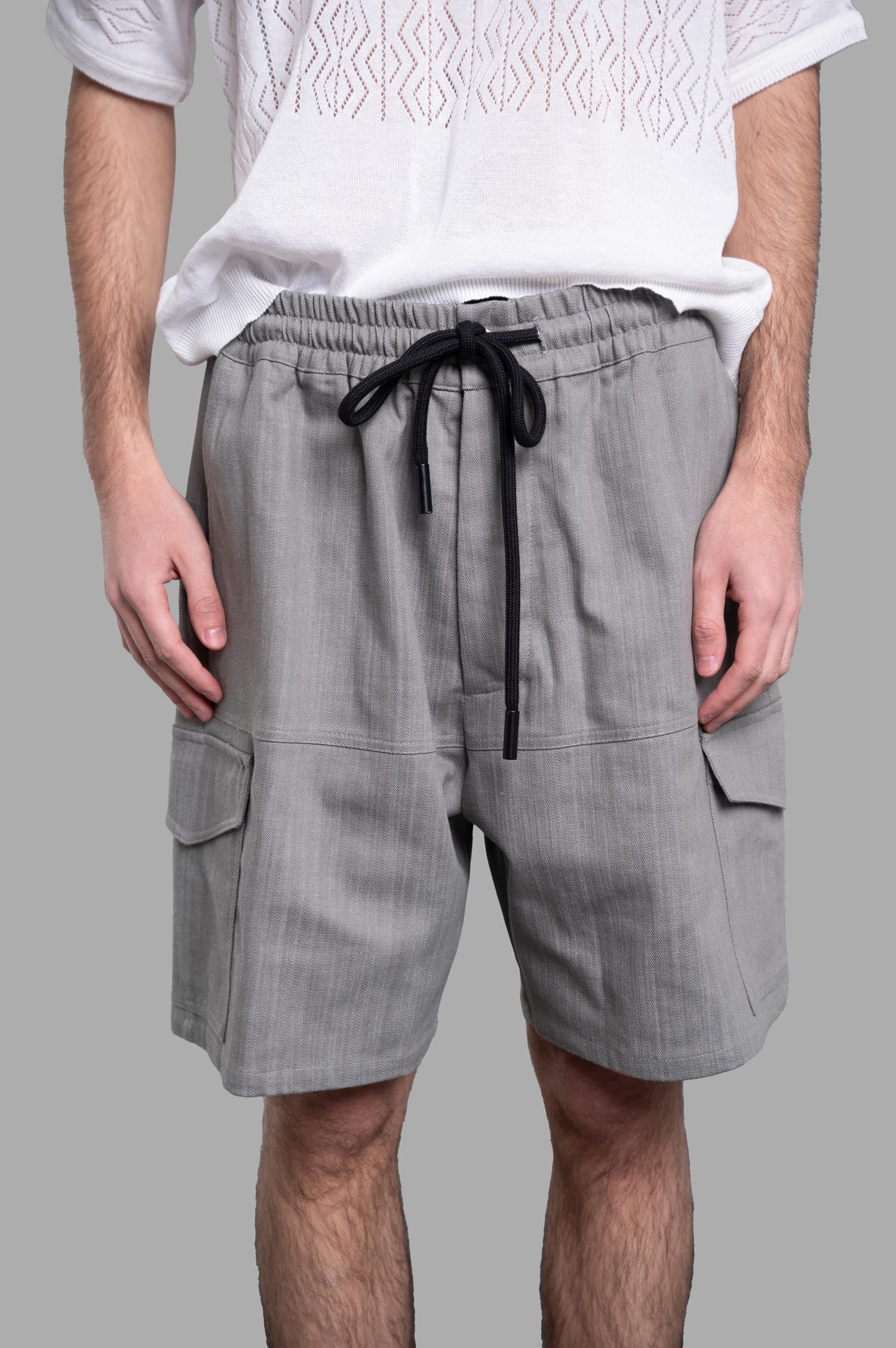 Gaëlle Paris Drawstring Bermudas in Grey, featuring adjustable waist, pockets, and stylish denim texture on model.