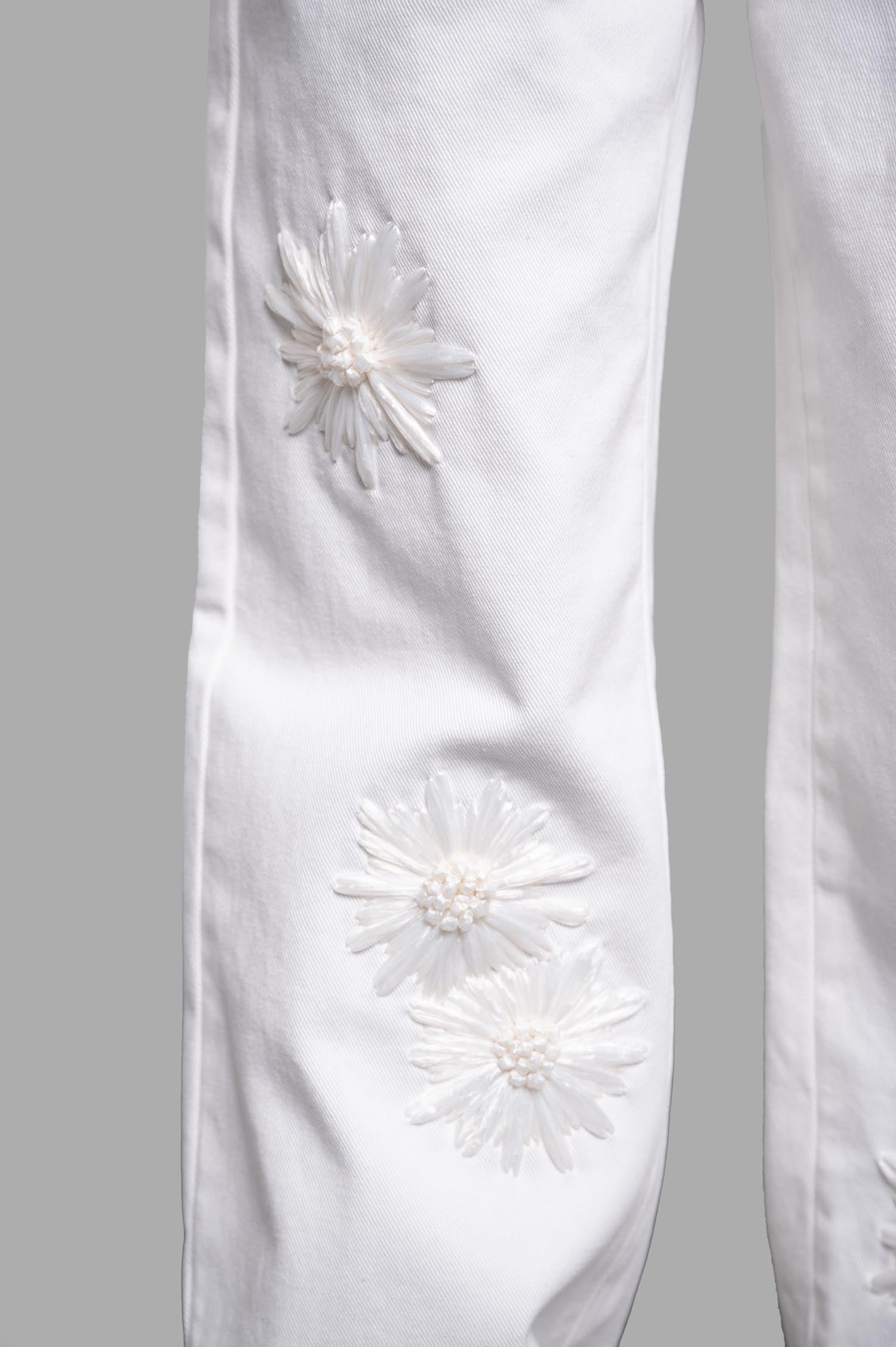 MSGM Denim Trousers with Raffia Flowers, showcasing embroidery detail on the front in elegant white cotton fabric.