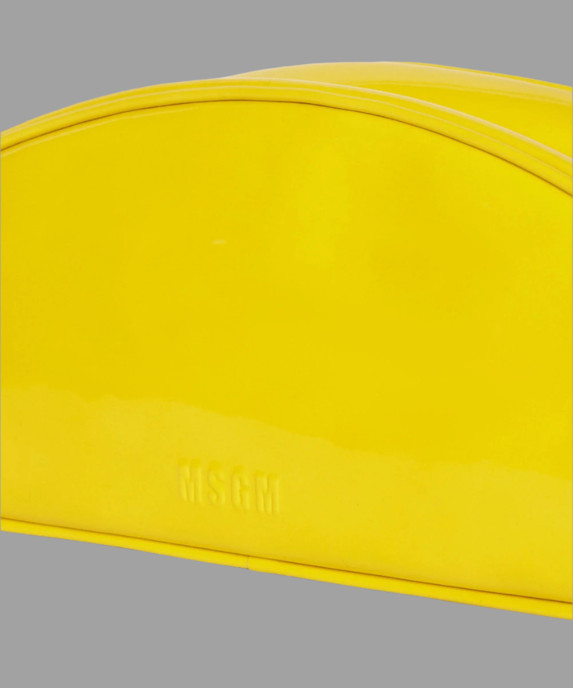 MSGM Patent Leather Handbag detail view showcasing the glossy yellow finish and embossed logo. Stylish and modern design.