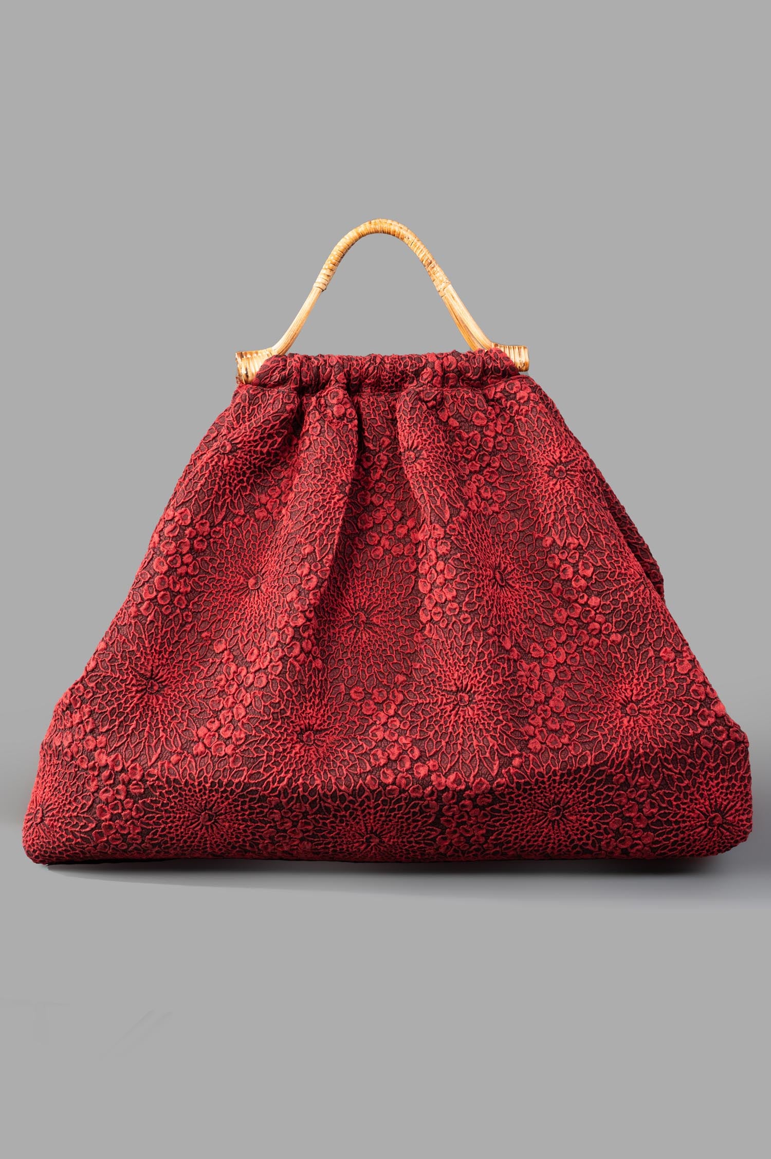 Marc Point XL Double-handle Bag in red, front view. Textured floral fabric adds elegance and sophistication.
