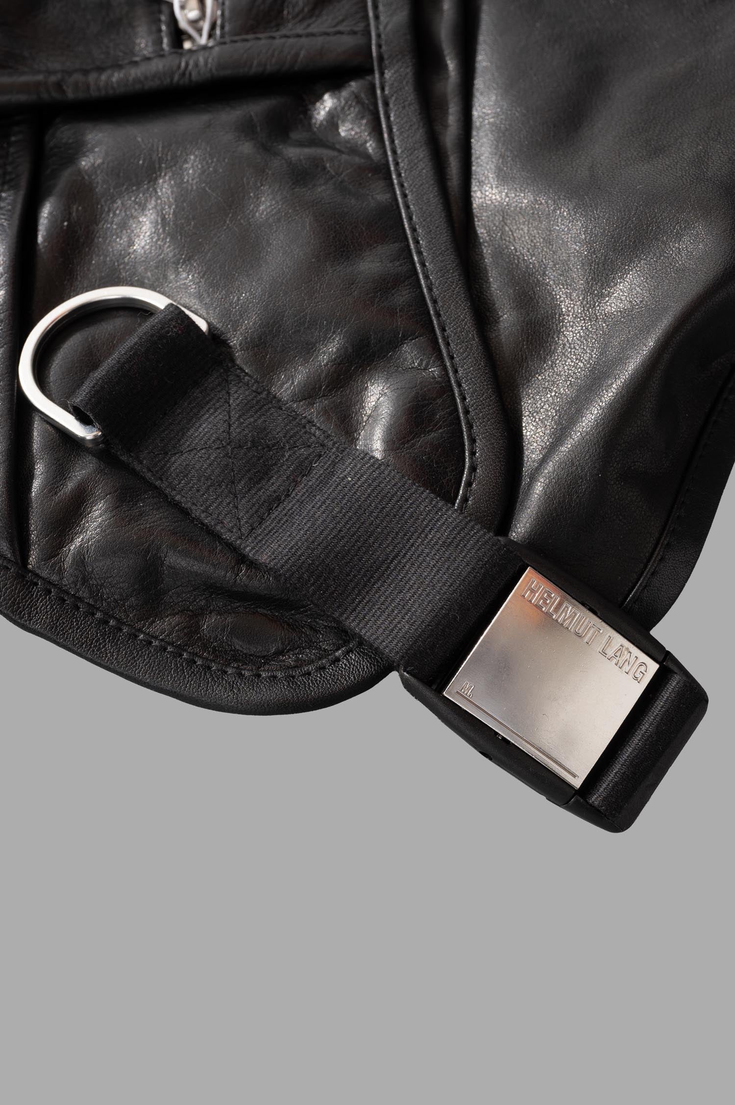 Helmut Lang Utility Bag Vest close-up of adjustable strap and metallic logo on textured black leather.