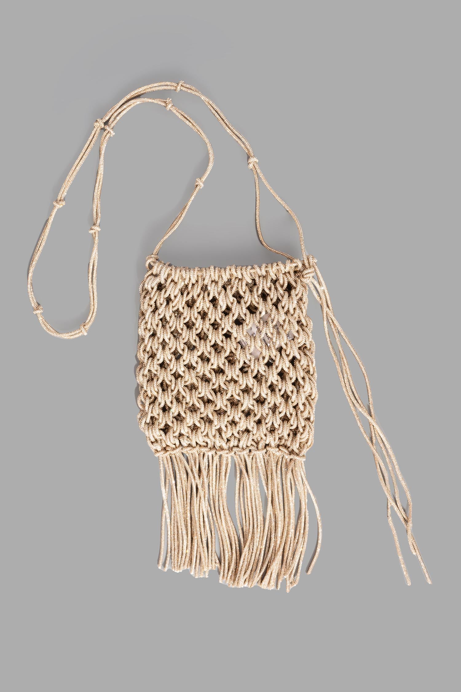 Gentry Portofino Gold Macrame Bag, front view, intricately woven with glitter rope, featuring fringe details.