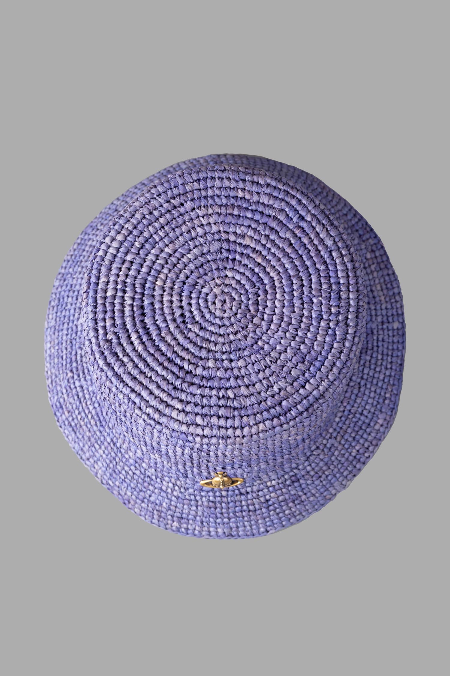 Vivienne Westwood Orb Raffia Bucket Hat, top view showcasing woven raffia texture and signature orb plaque detail in blue.