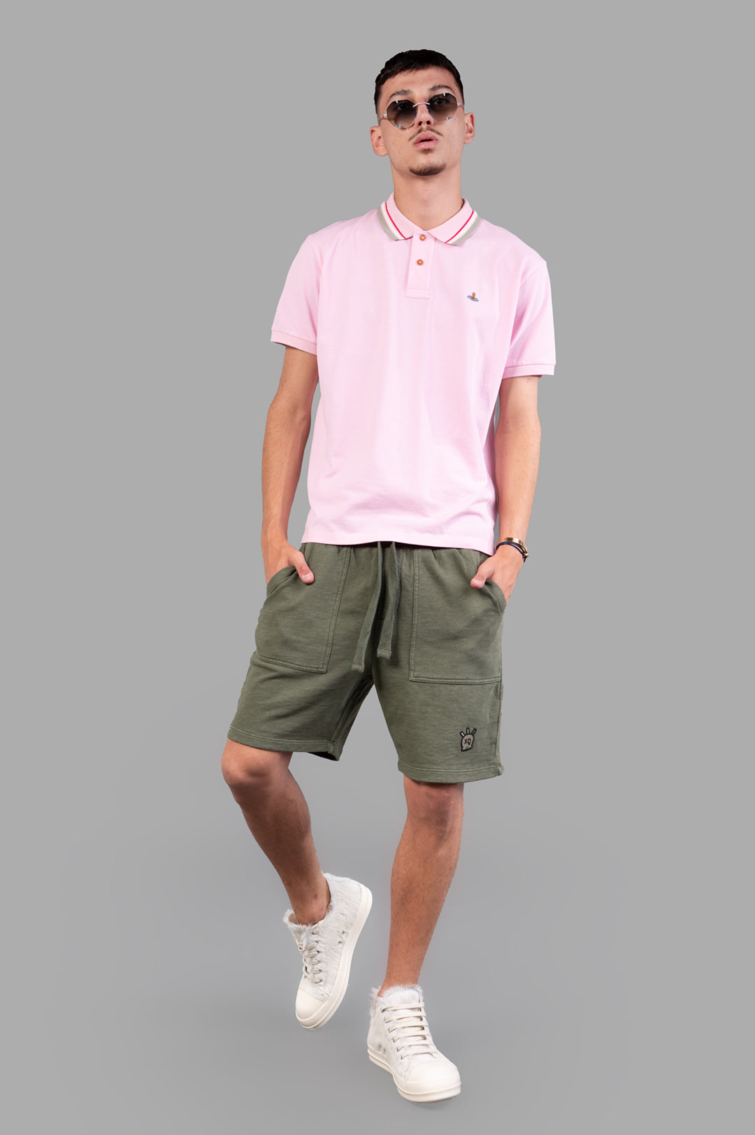 Vivienne Westwood Classic Logo Polo Shirt in pink, front view on model, with striped neck and iconic orb detail.