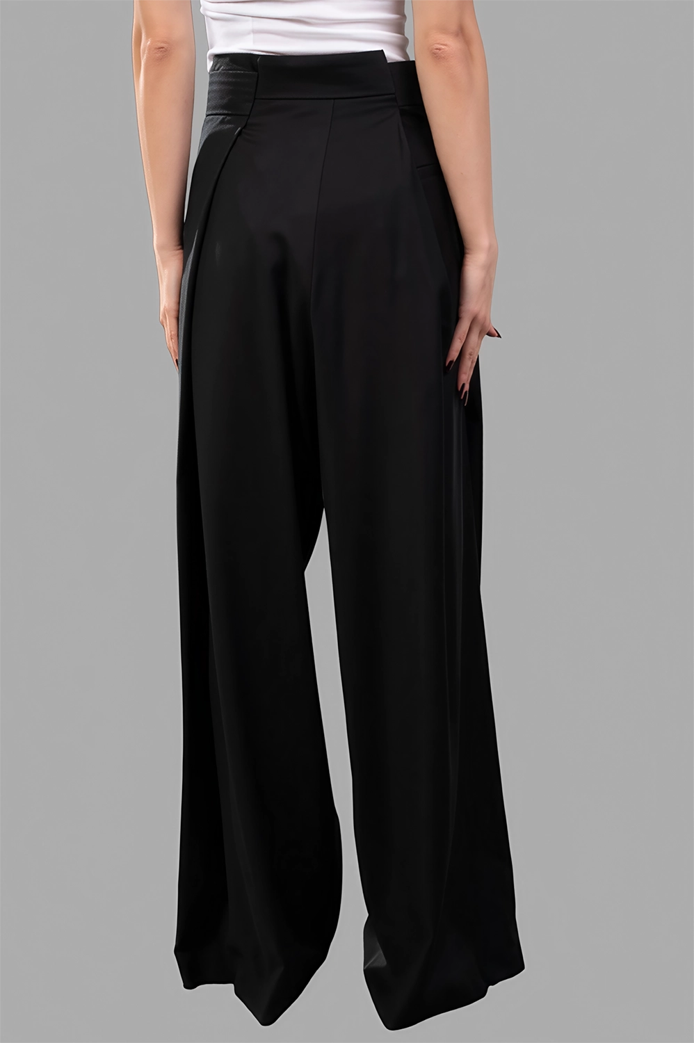 Natasha Zinko Folded trousers in black wool, showcasing soft draping and high-rise waistband from the back view.