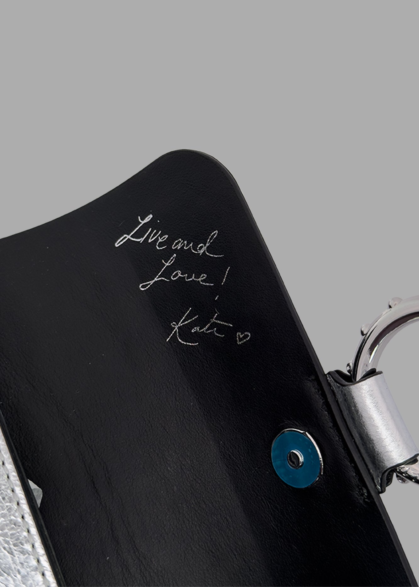 Zadig & Voltaire Kate Mini Bag detail view showcasing embossed signature and silver-tone hardware in sleek black leather.