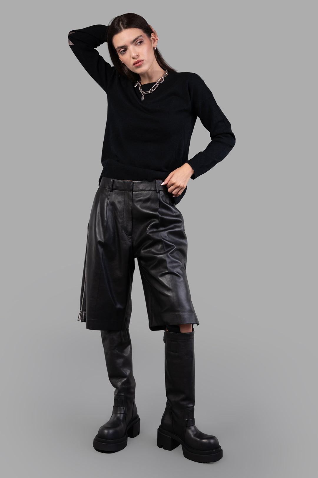 Helmut Lang black Leather Zoot Shorts, wide-leg, knee-length, shown on-model with adjustable side slit zippers.
