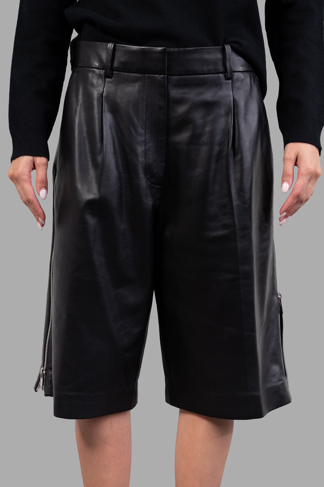 Helmut Lang Leather Zoot Shorts in black, showcasing wide-leg design and metal zippers on adjustable side slits.