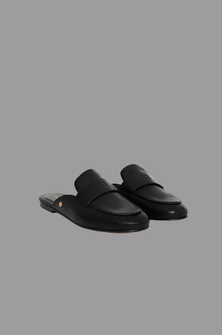 Anine Bing Corrine Mules in black, showcasing faux lizard-embossed leather with slip-on design and gold-tone details.