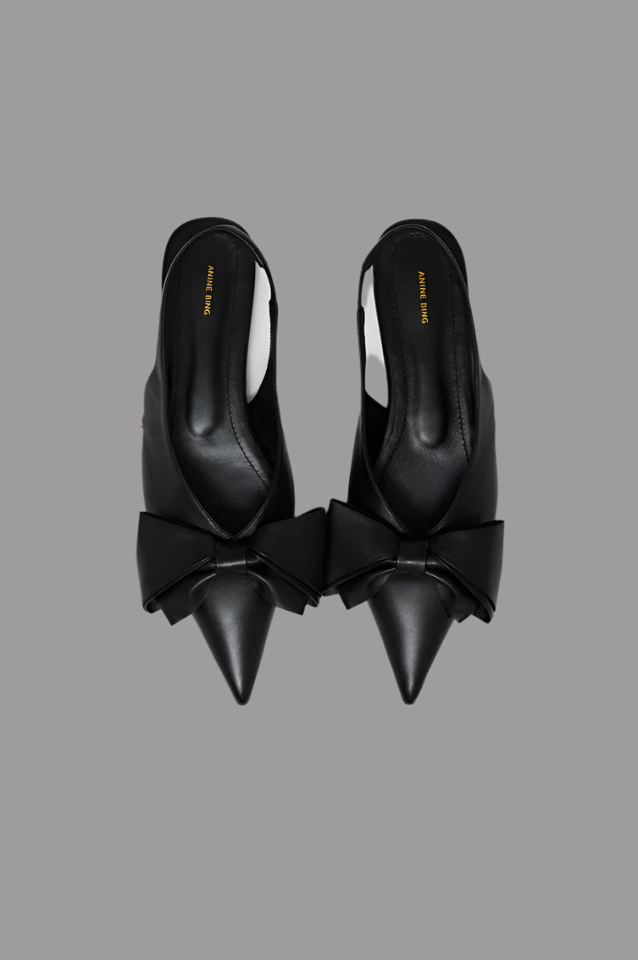 Anine Bing Nina Slingback Bow Flats, top view featuring oversized leather bow and pointed toe in soft black Nappa leather.