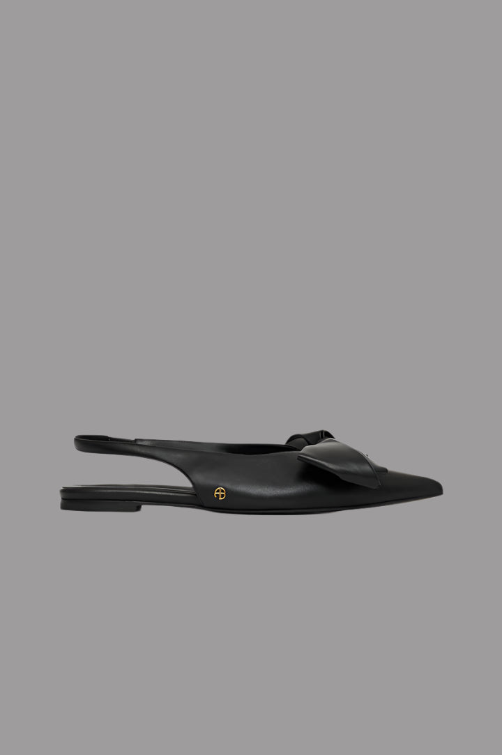 Anine Bing Nina Slingback Bow Flats in black Nappa leather, side view, featuring oversized bow and gold-tone hardware.