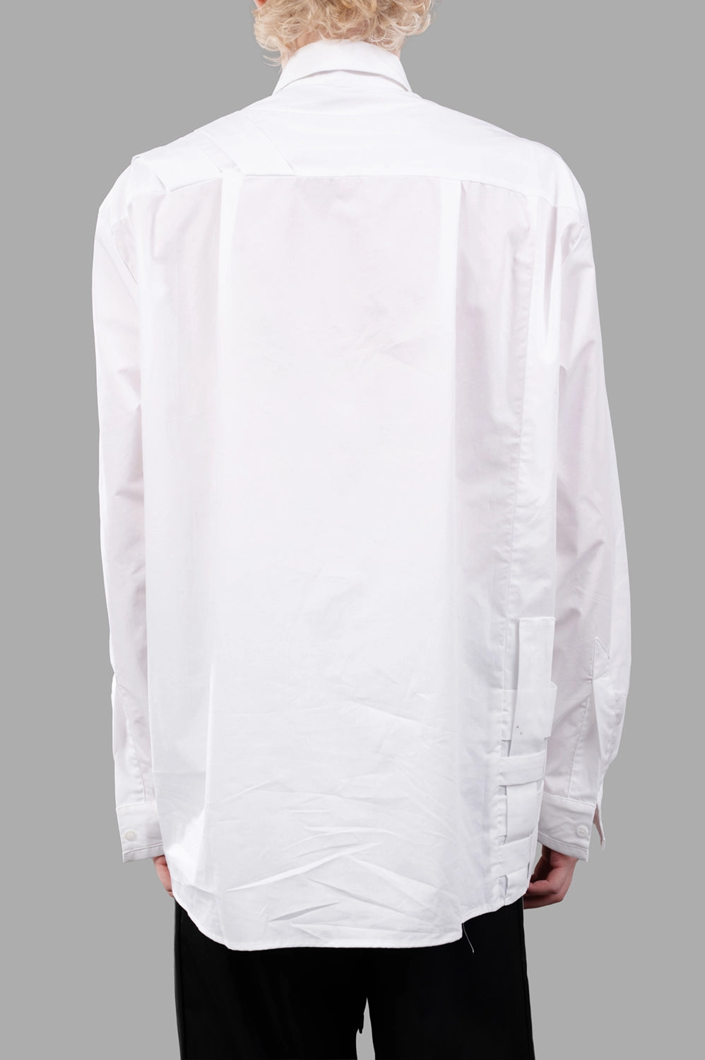 Back close-up of white shirt with clean yoke and long sleeves, minimal detailing
