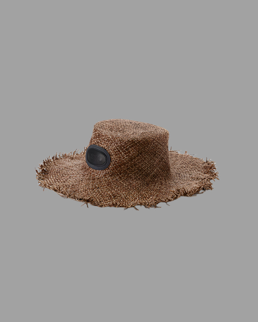 Kijima Takayuki Wide-brim Straw Hat in brown raffia, side view showcasing frayed edges and textured craftsmanship.