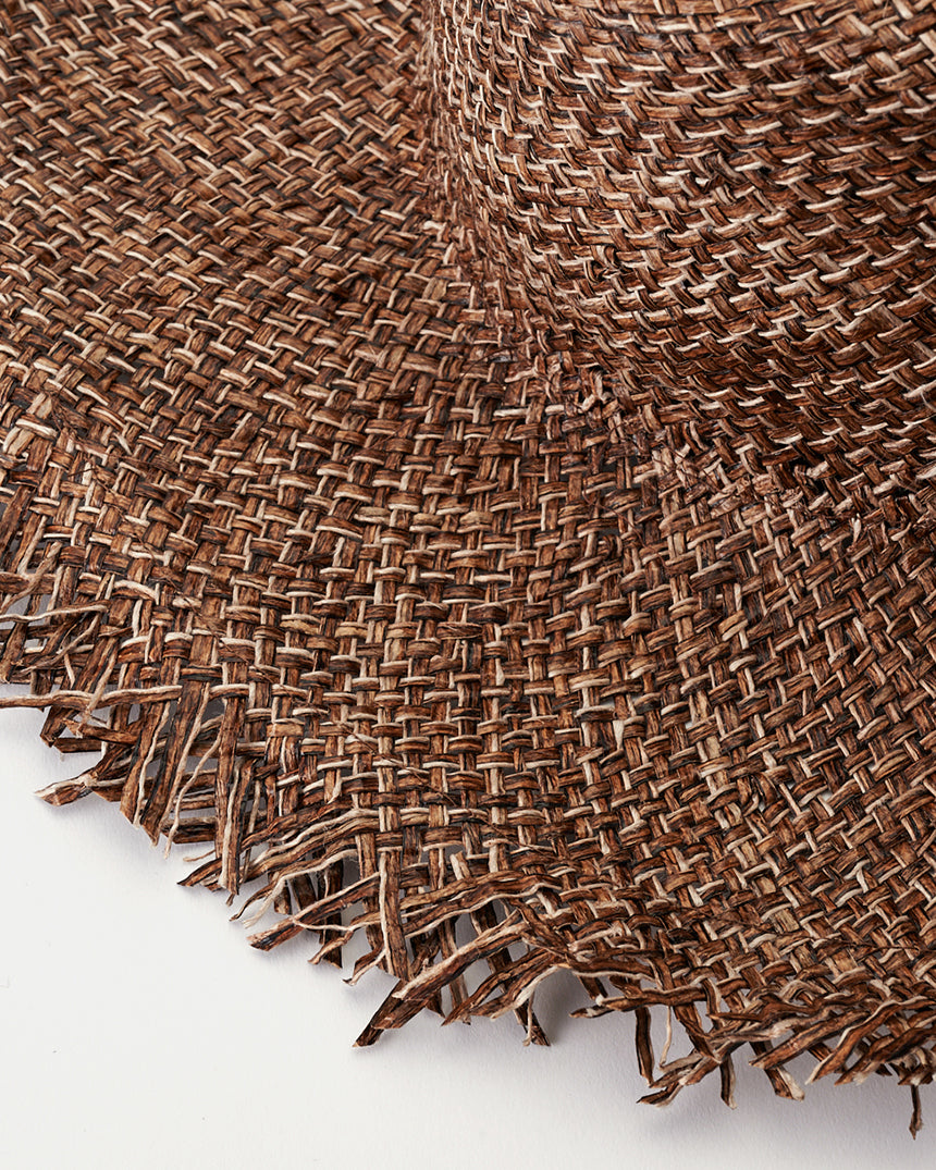 Kijima Takayuki Wide-brim Straw Hat featuring a close-up of the intricate brown raffia weave and textured edges.