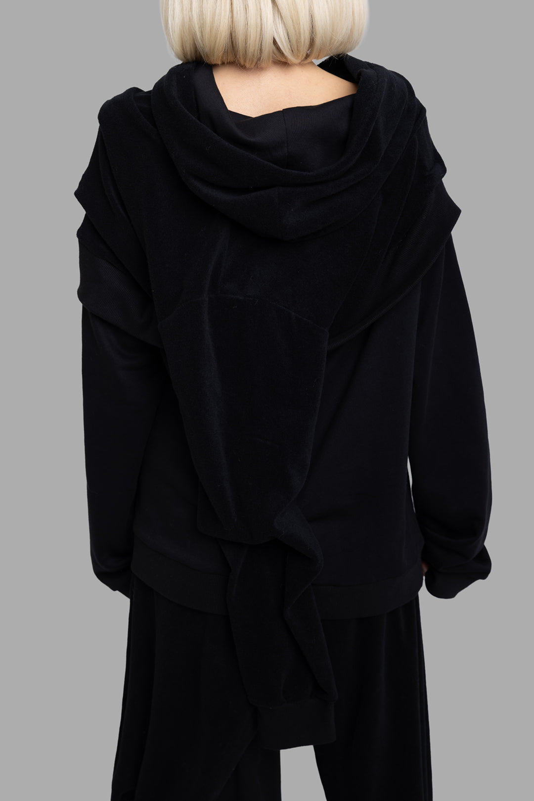 Natasha Zinko unisex Aftercare hoodie in black, back view with extended draped panel falling from hood