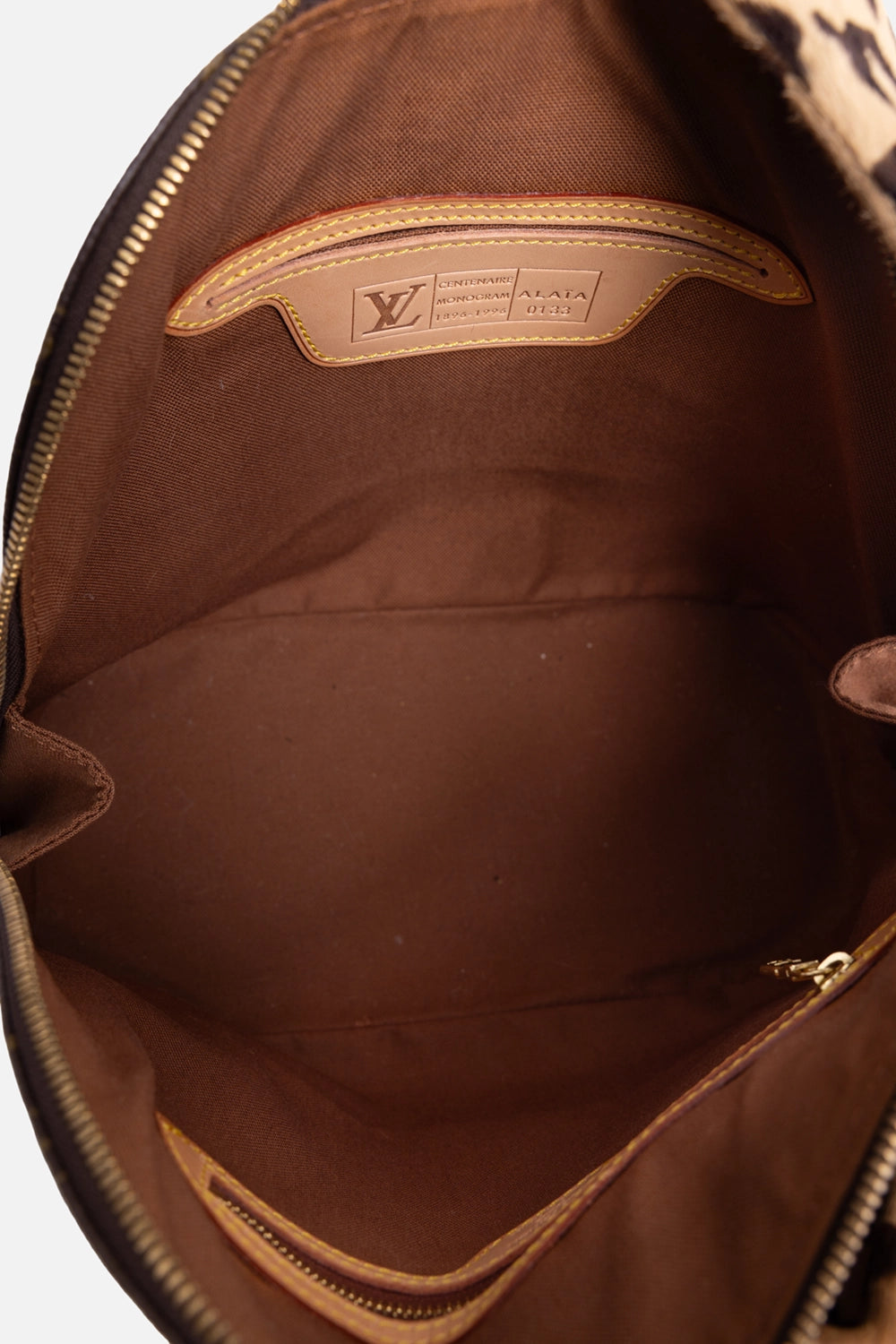 Pre-owned Louis Vuitton Alma bag in monogram brown, interior view, leather Centenaire Monogram Alaïa plaque
