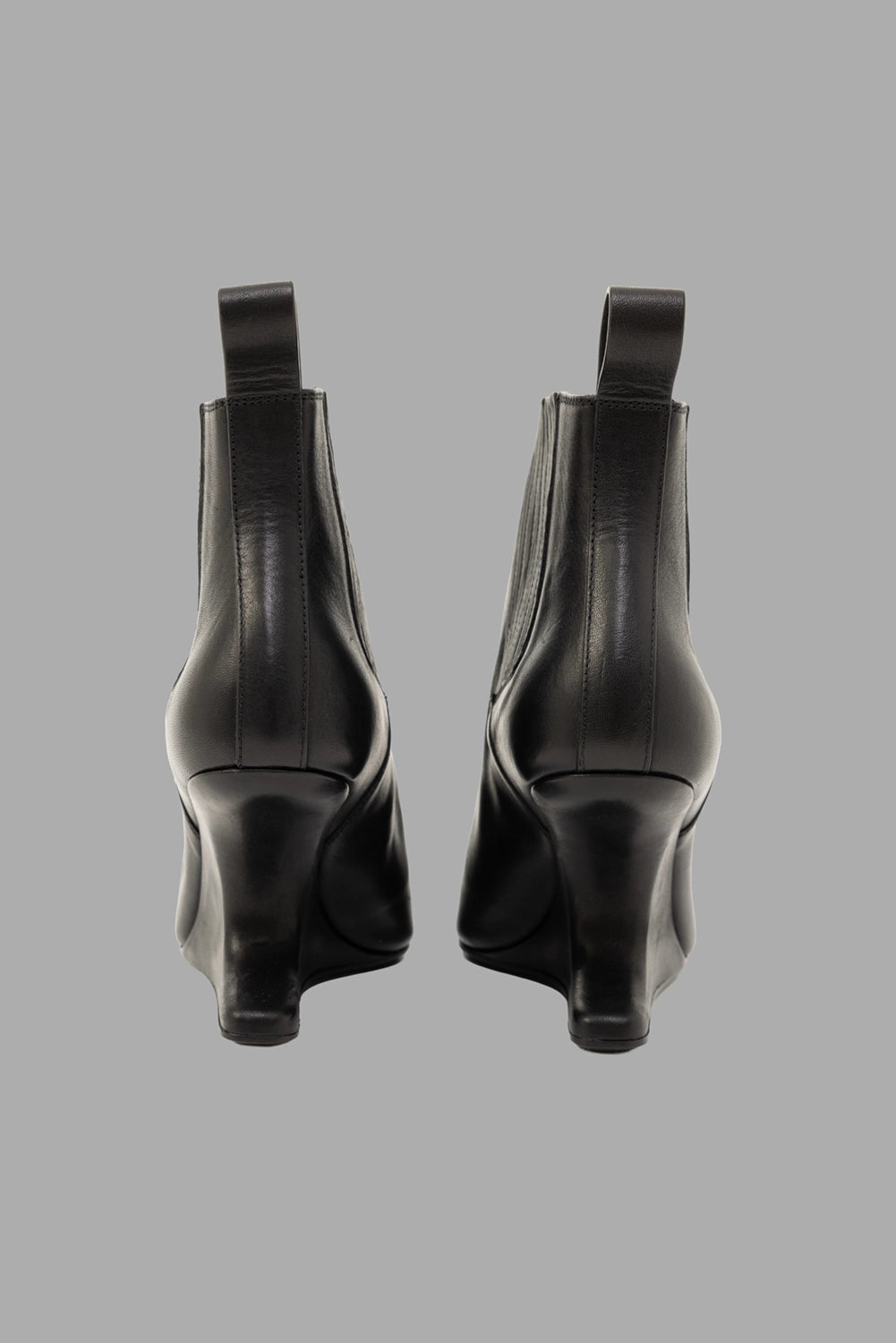 Rick Owens women's ankle boots in black, back view, pull tabs and curved cantilever heels
