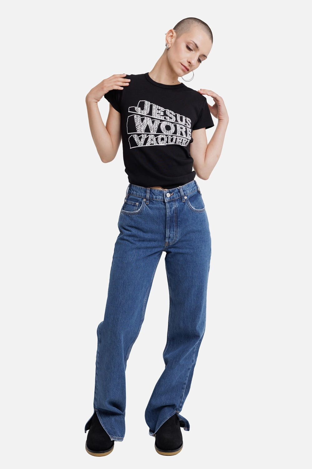 Vaquera women's black baby T-shirt, full-length model view with white Jesus Wore Vaquera graphic