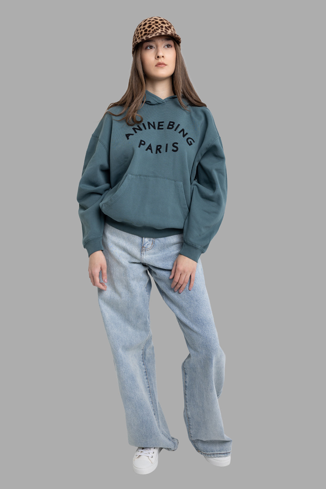 Natasha Zinko women's baggy jeans in light wash, full-length front on model with high-rise waist and extra-long wide leg