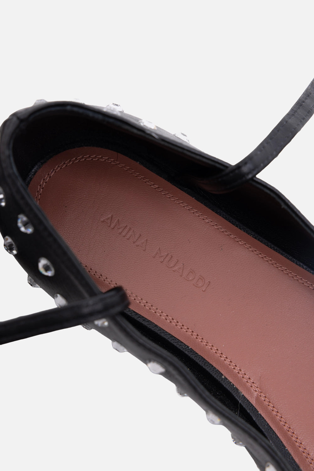 Pre-owned Amina Muaddi women’s ballet flats in black, insole close-up, embossed logo on brown leather footbed
