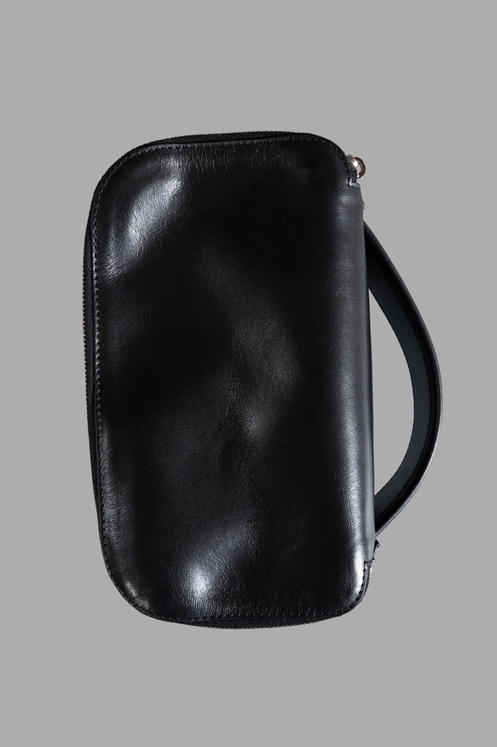 Rick Owens beauty case in black, front view with zip-around top and rounded corners