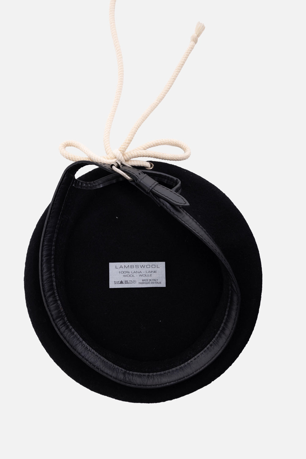 Pre-owned Sellam unisex beret in black, interior view, lambswool label and white rope ties through metal eyelets
