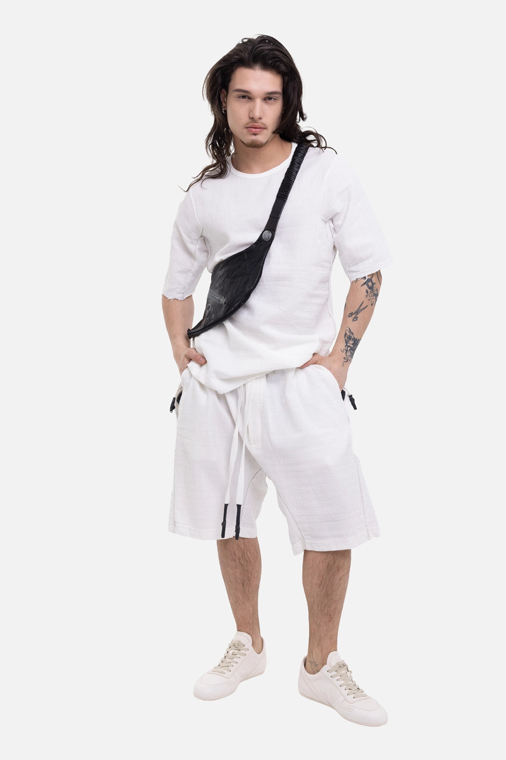 69 by Isaac Sellam men's shorts in white, on-model full-length view with drawstring waist and textured fabric