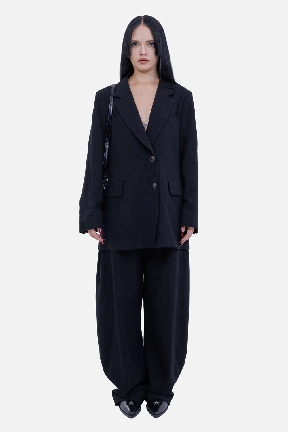 Gentry Portofino women's black blazer, on-model view with notch lapels, two-button front and relaxed longline fit