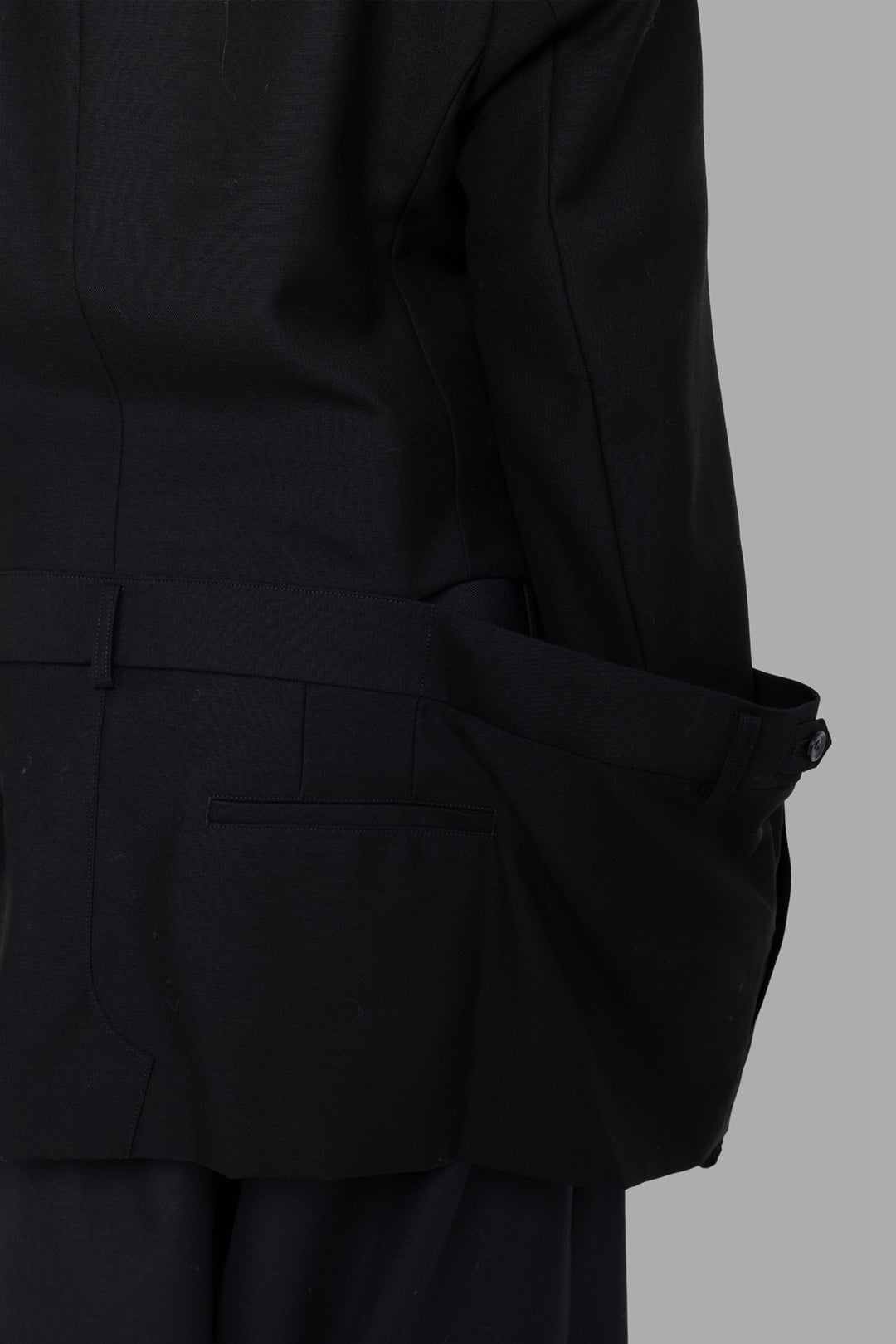 Noir Kei Ninomiya women black blazer, waistband detail, right welt pocket and adjustable belt tab