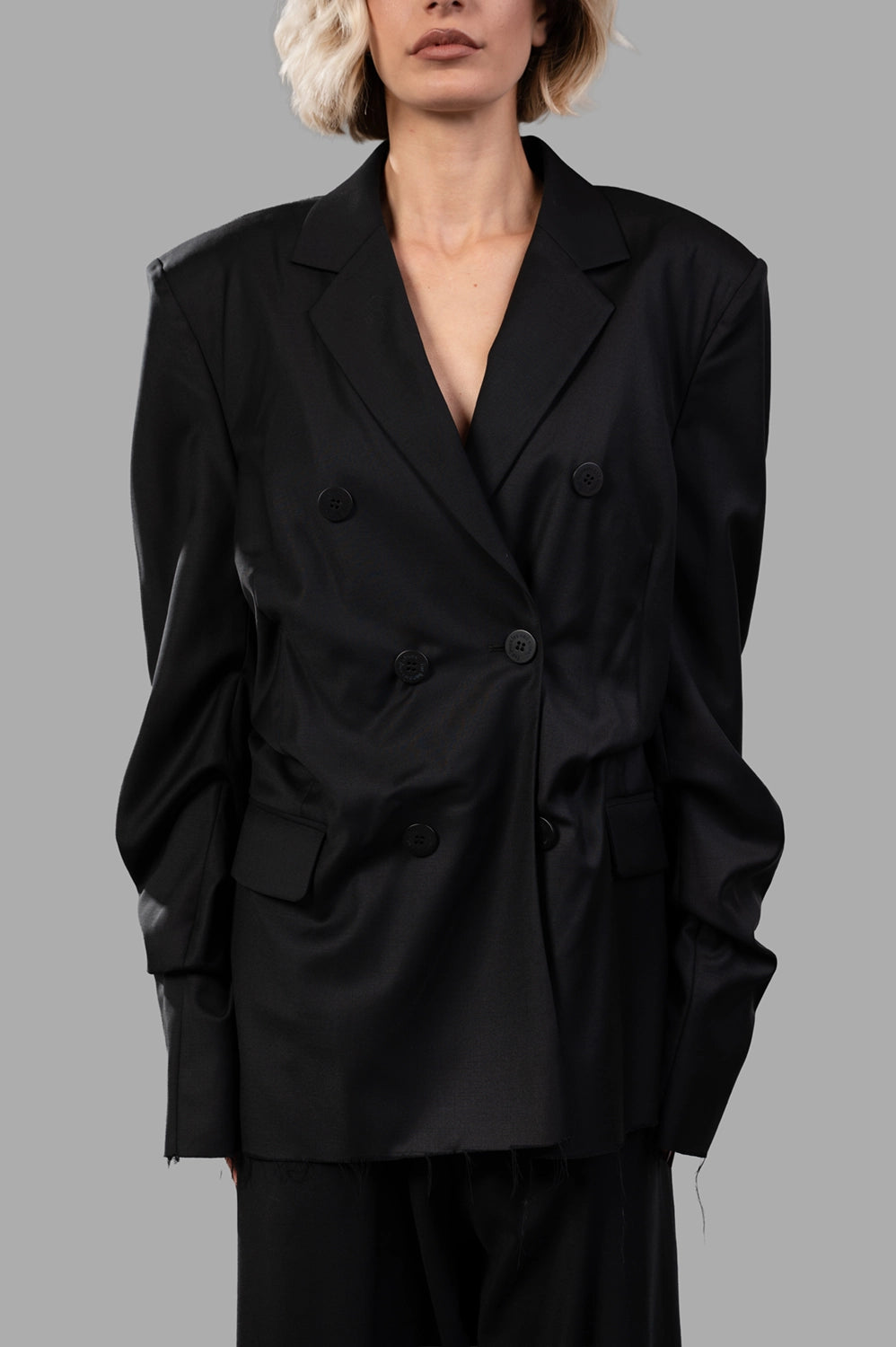 Natasha Zinko blazer in black wool‑blend, front view, double‑breasted buttons and flap pockets visible