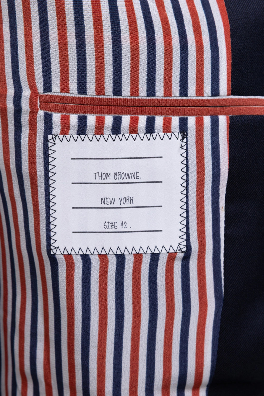 Pre-owned Thom Browne blazer in navy, interior label view, signature striped lining and size 42 label