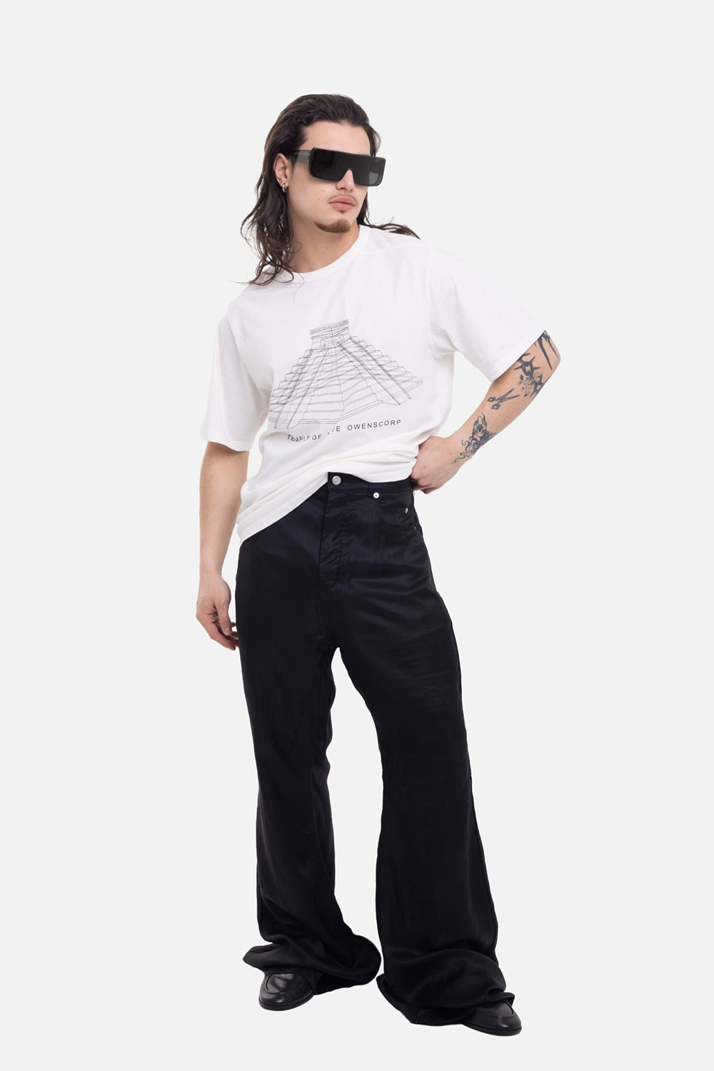 Rick Owens men's Bolan Bootcut jeans in Black, on-model full-length with glossy flare and stacked hems