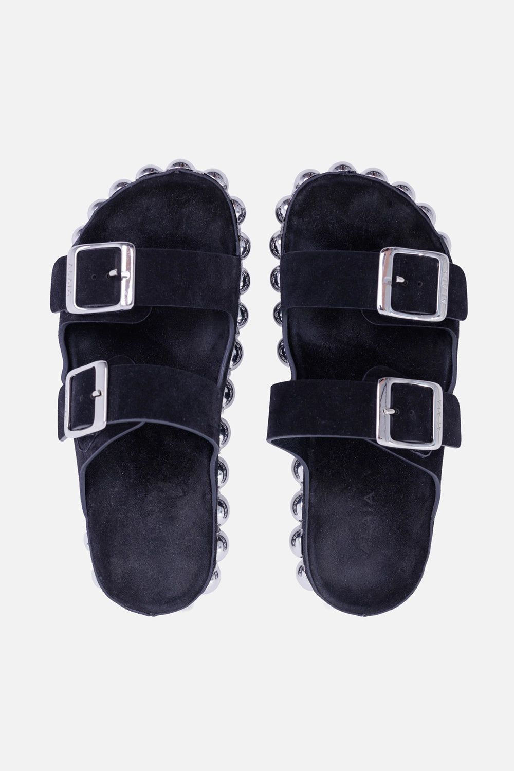 Alaïa women's Bombe suede slides in black, top view with two wide suede straps and oversized silver buckles