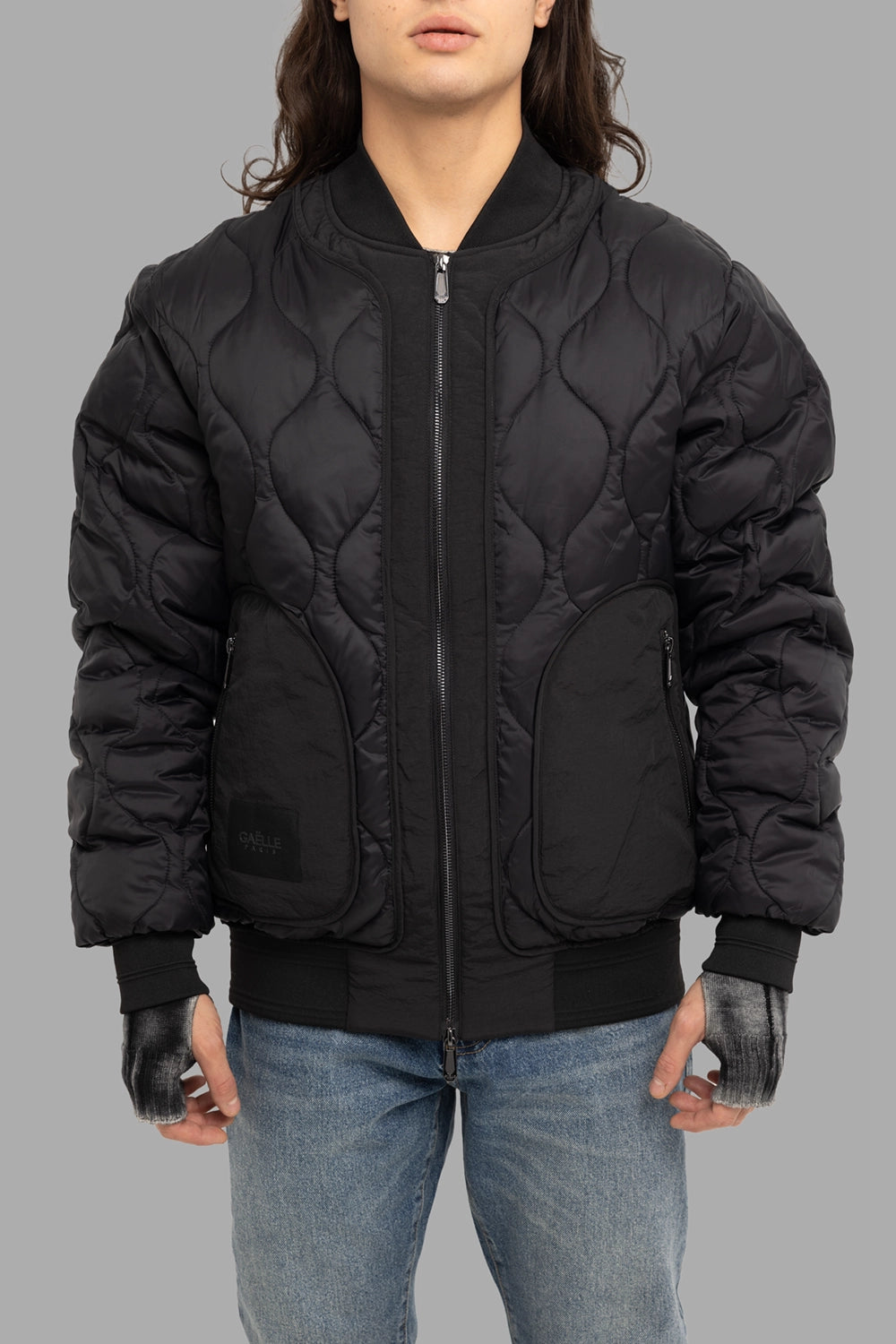 Gaëlle Paris men's bomber jacket in black, front view, two-way zip and oversized curved pockets, ribbed trims