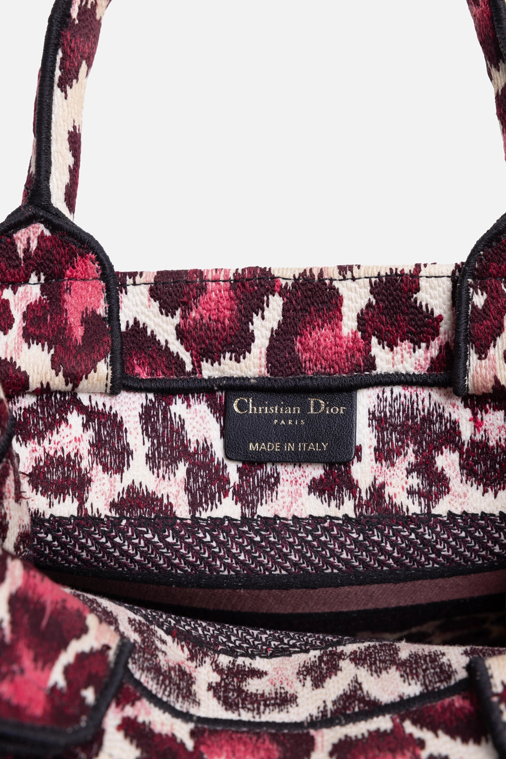 Pre-owned Christian Dior book tote in pink leopard, interior label view, leather patch stamped Made in Italy
