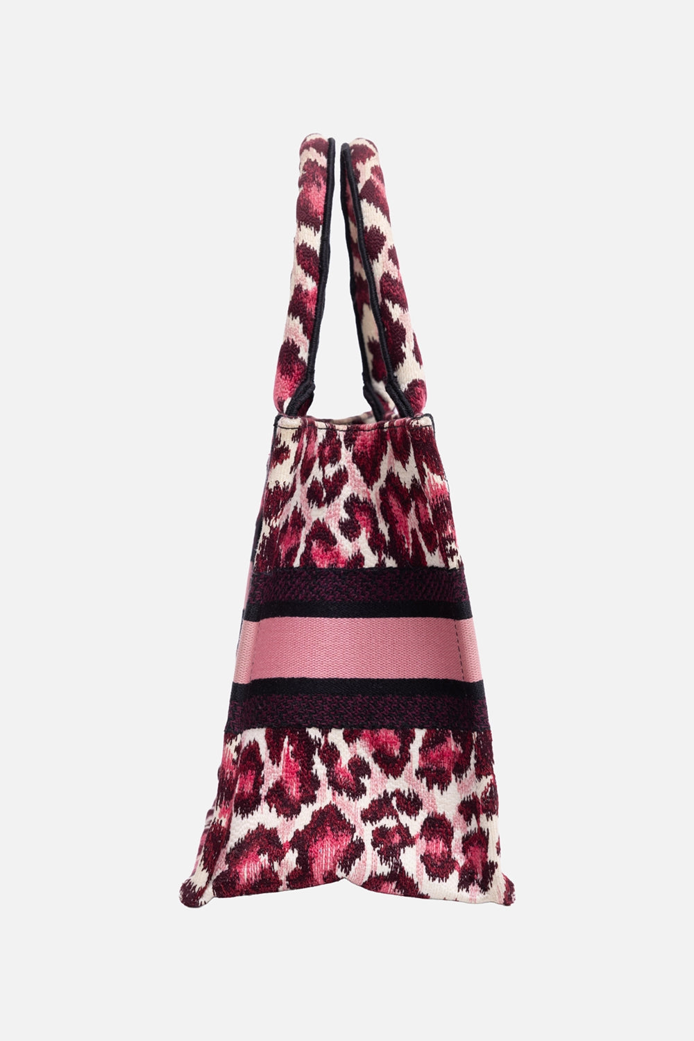 Pre-owned Christian Dior women's book tote in pink leopard, side view, gusseted profile and rolled handles
