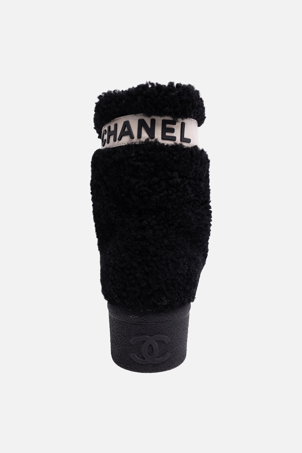 Pre-owned Chanel women’s boots in black, sole view, rubber tread with large logo lettering and Made in Italy stamp.