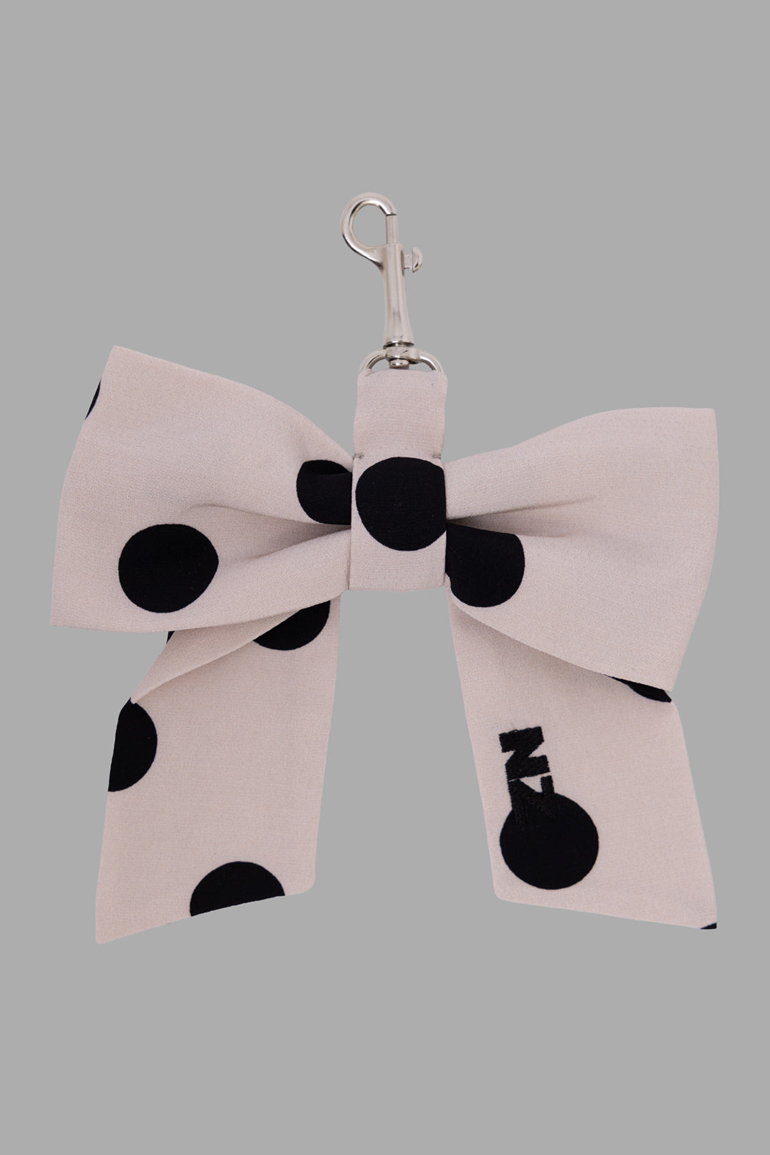 Natasha Zinko women's silk bow charm in beige, front view, black polka dots and NZ logo tail, silver clasp