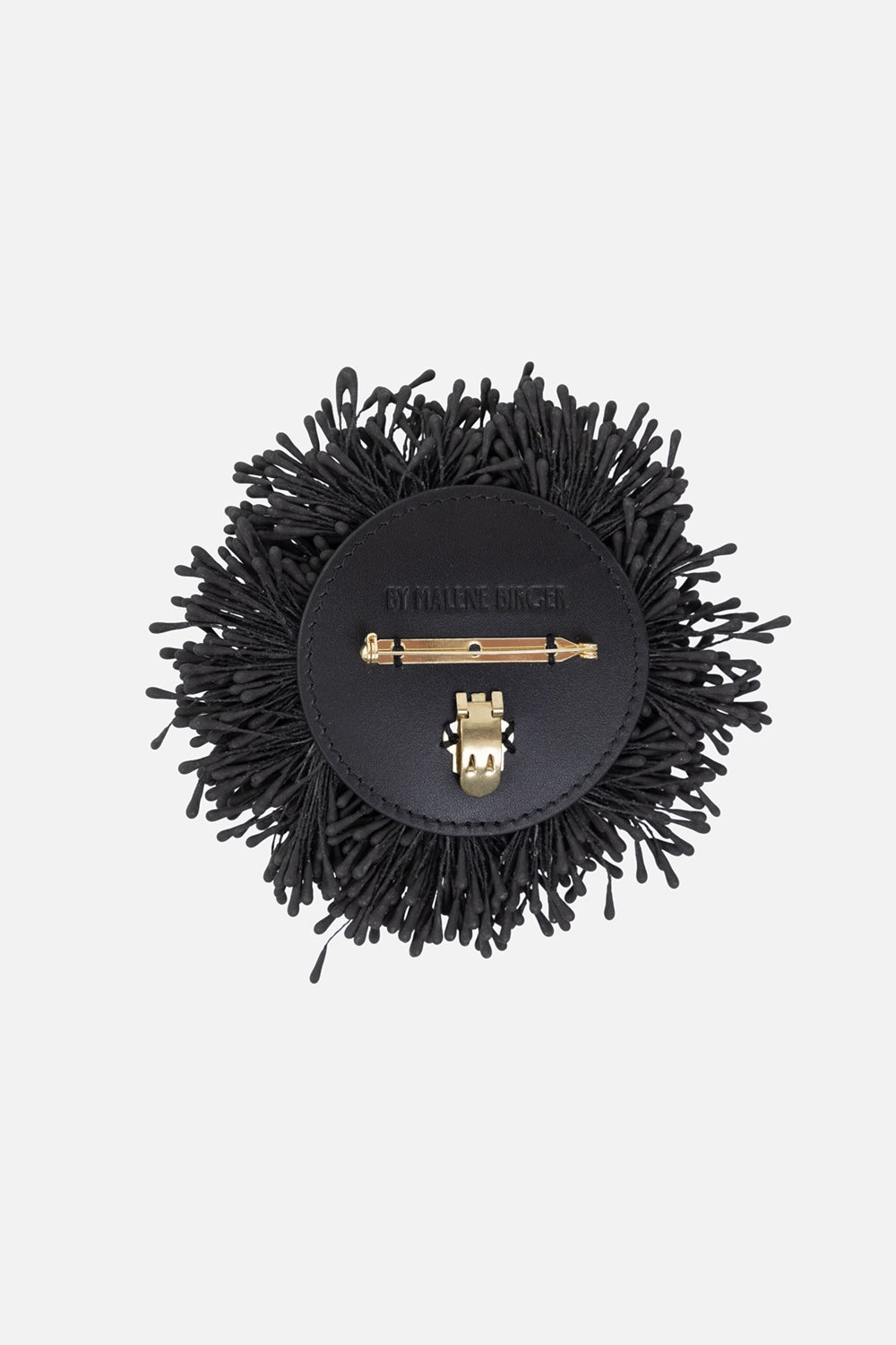 By Malene Birger women's brooch in black, back view, leather backing with gold-tone pin and clip.