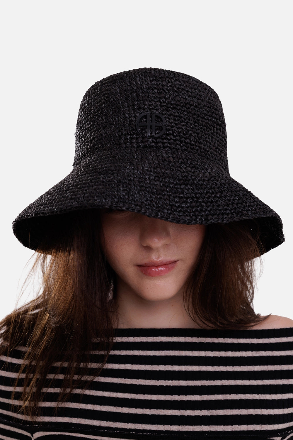 Anine Bing women's black raffia bucket hat, on-model front view with tonal AB logo and sloping brim
