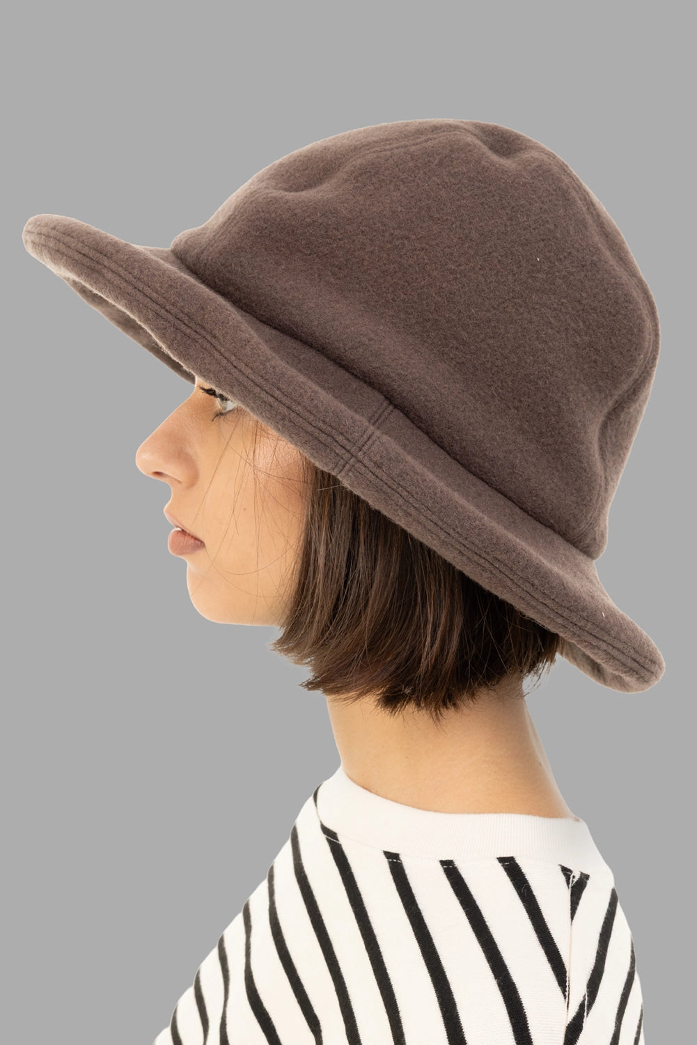 KIJIMA TAKAYUKI unisex wool felt bucket hat in taupe, side view, wide rolled brim and seamed crown.