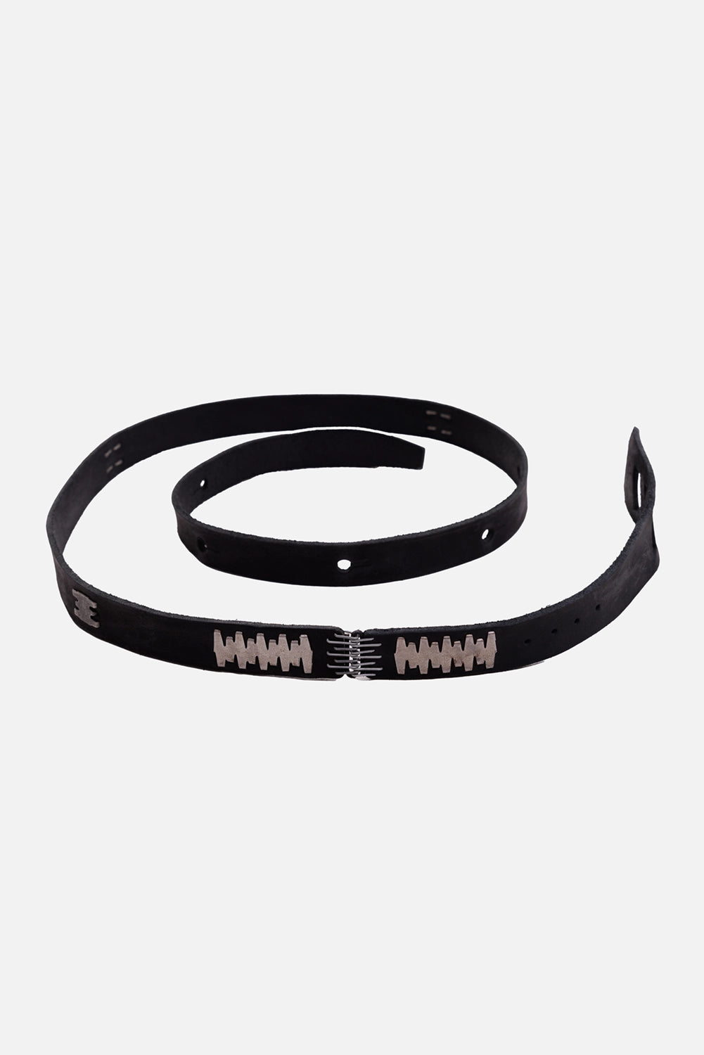 Isaac Sellam calf leather belt in black, coiled three-quarter view with connecting-spine hardware and punched holes